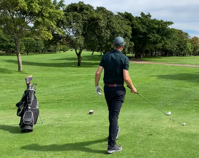 A golfer in deep though before a shot. One approach to overcome golf anxiety.